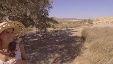 Naked girl records a video against scenic landscapes